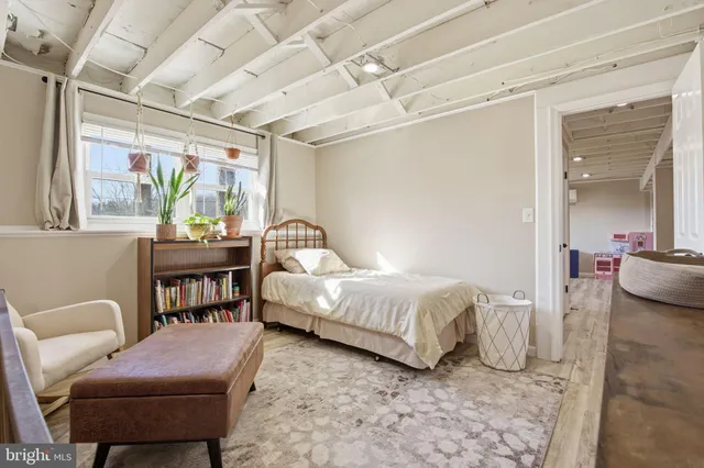 a bedroom with furniture and a potted plant