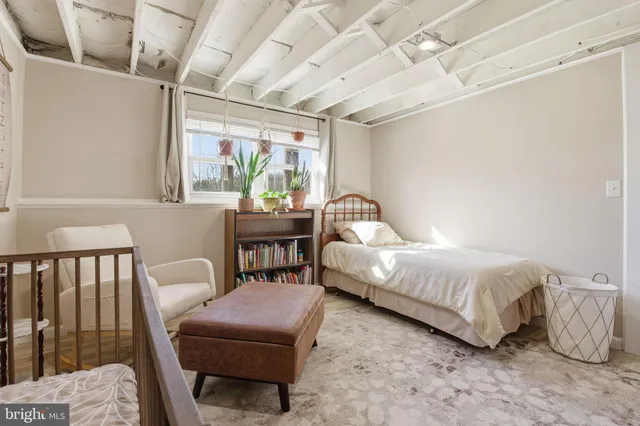 a bedroom with furniture and a large window