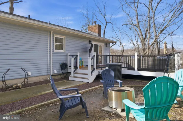 a view of a patio with table and chairs with wooden fence