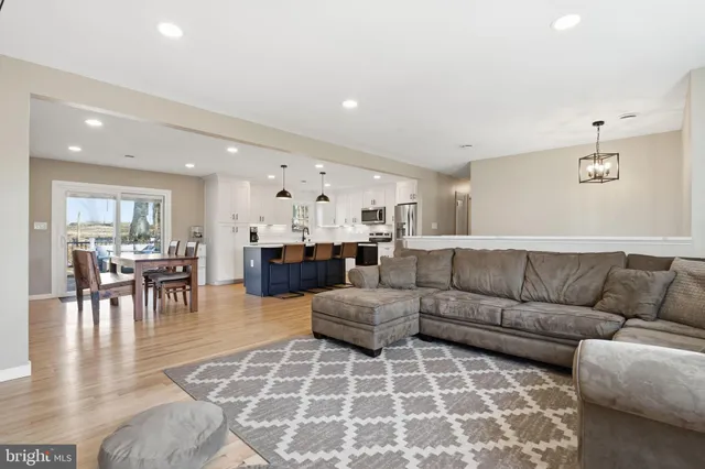 a living room with furniture and kitchen view