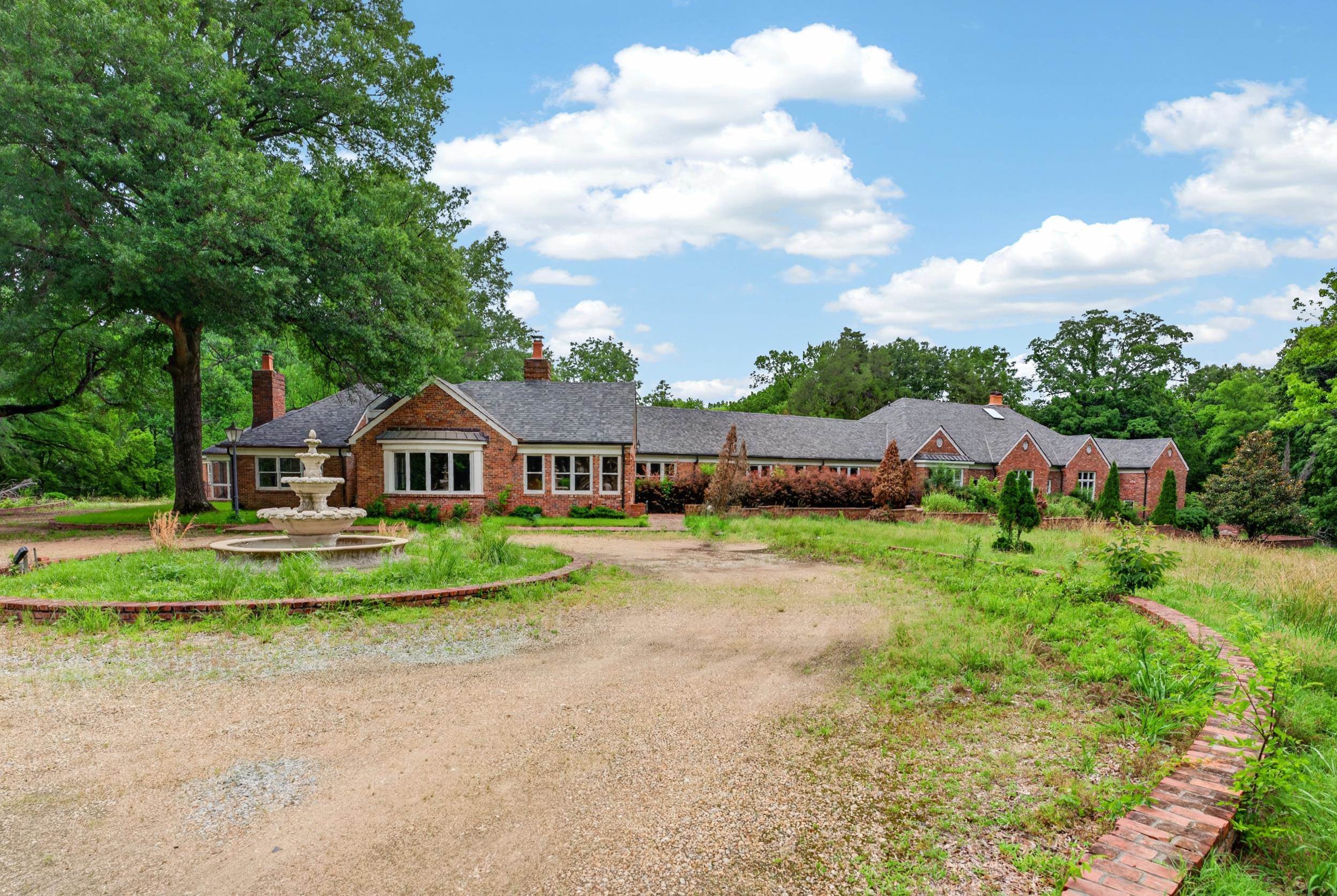 530 West Raines Road Memphis, TN 38109 - Photo 4 of 38 Brick ranch-style exterior with multiple gables and a dark shingle roof