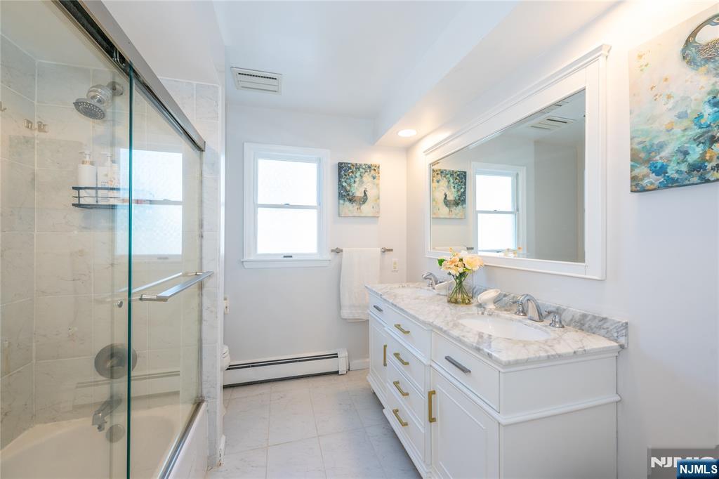690 Garden Street Maywood, NJ 07607 - Photo 36 of 49 a bathroom with a granite countertop sink mirror and a bathtub