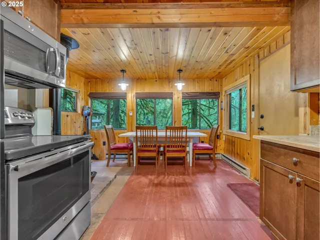 a view of a kitchen with a large window and sitting area