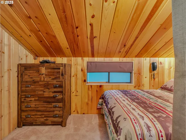 a bedroom with a bed and a ceiling fan