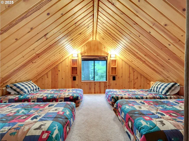 a bedroom with two beds and a chandelier