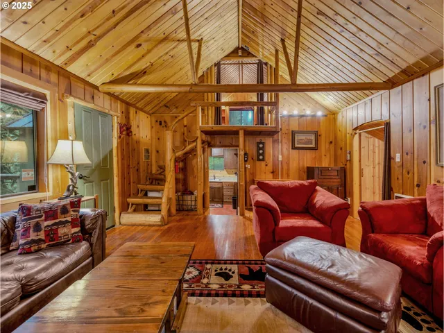 a living room with furniture a wooden floor and next to a window