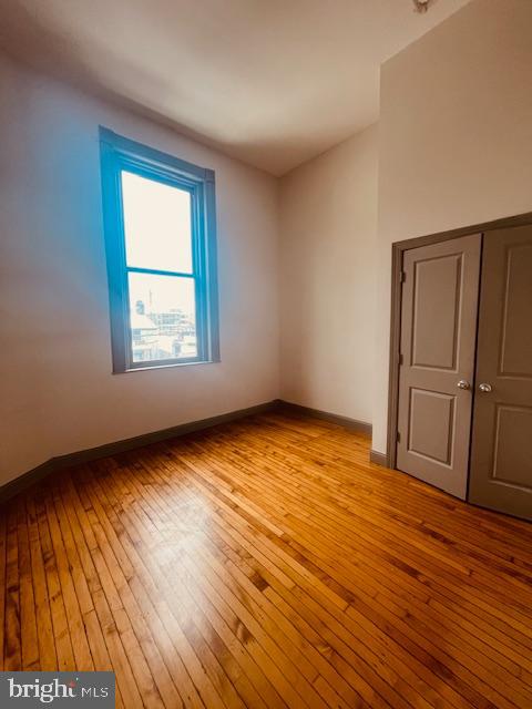 511 South Bond Street, Unit 304 Baltimore, MD 21231 - Photo 14 of 16 an empty room with wooden floor and cabinet
