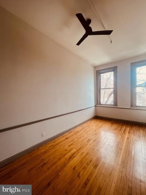 511 South Bond Street, Unit 304 Baltimore, MD 21231 - Photo 4 of 16 a view of empty room with wooden floor and fan