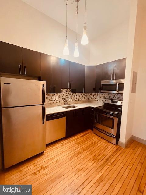 511 South Bond Street, Unit 304 Baltimore, MD 21231 - Photo 7 of 16 a kitchen with a refrigerator and a stove top oven