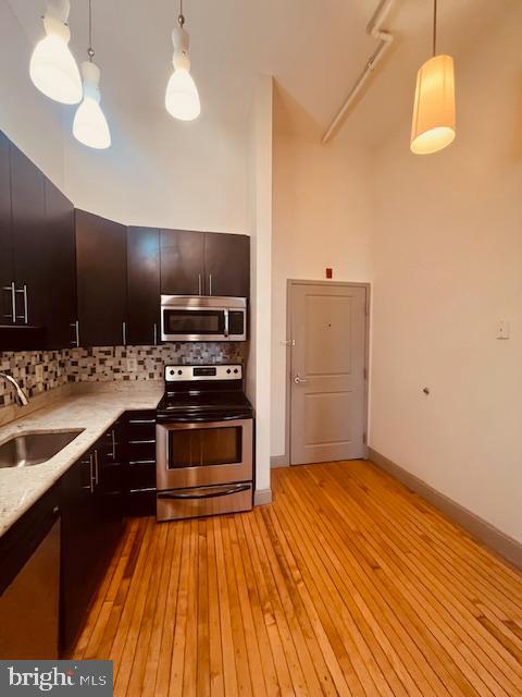 511 South Bond Street, Unit 304 Baltimore, MD 21231 - Photo 8 of 16 a kitchen with stainless steel appliances a stove a sink and a refrigerator