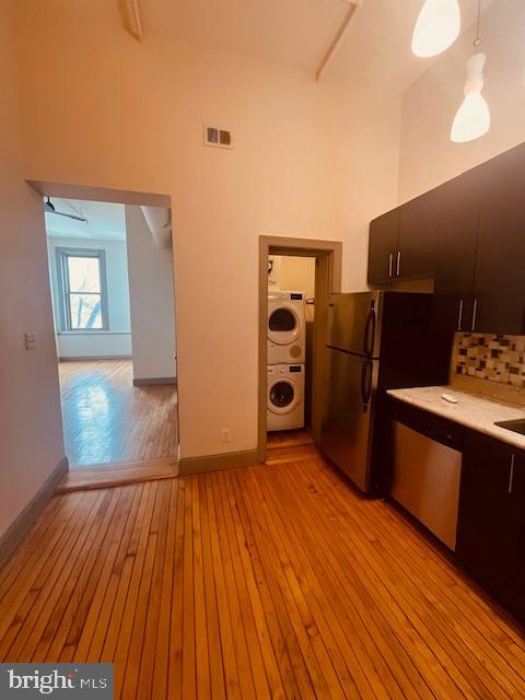 511 South Bond Street, Unit 304 Baltimore, MD 21231 - Photo 10 of 16 a view of a kitchen with refrigerator and wooden floor
