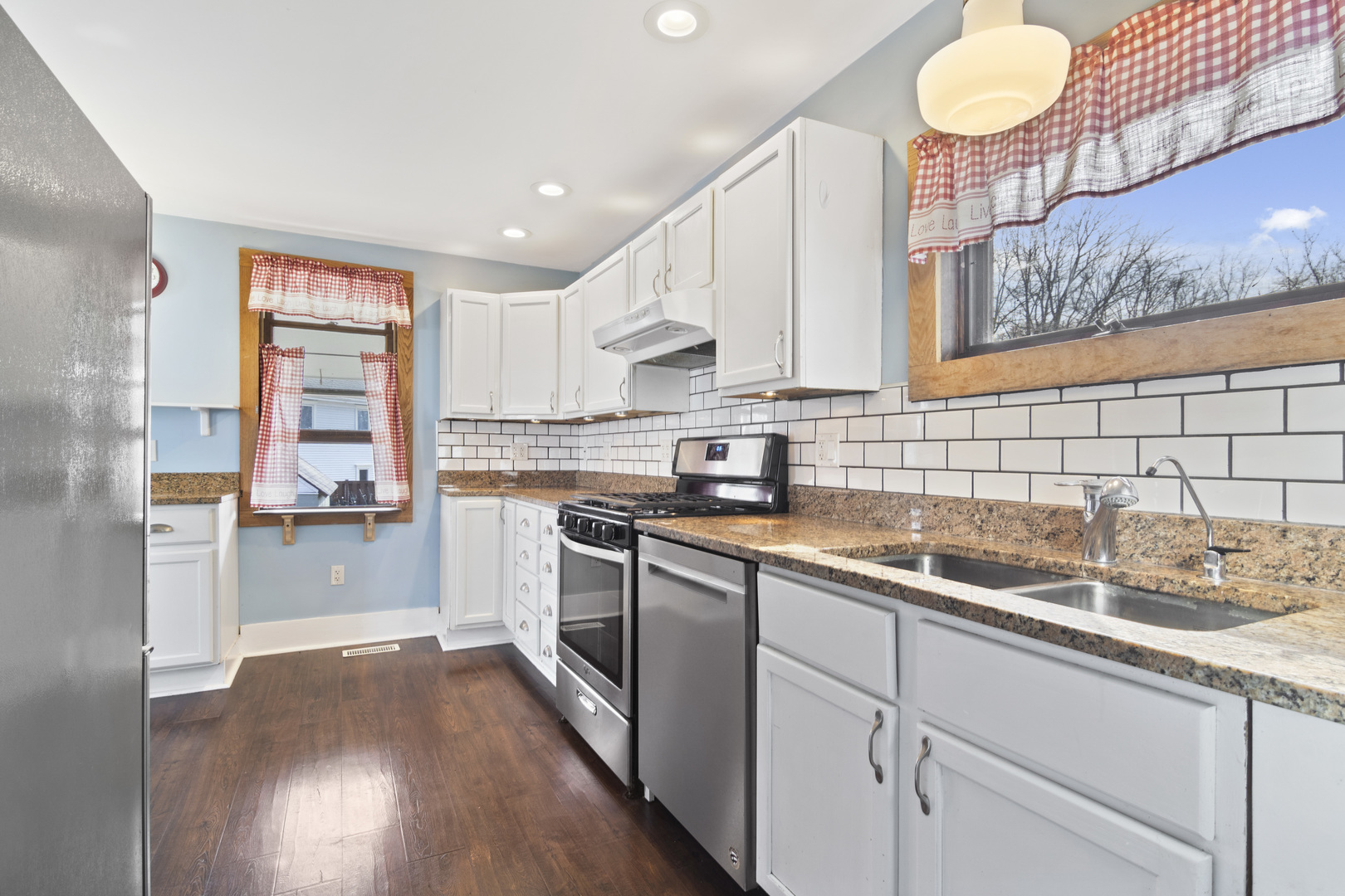 107 Spring Street Cary, IL 60013 - Photo 3 of 23 a kitchen with a sink cabinets stainless steel appliances and a window