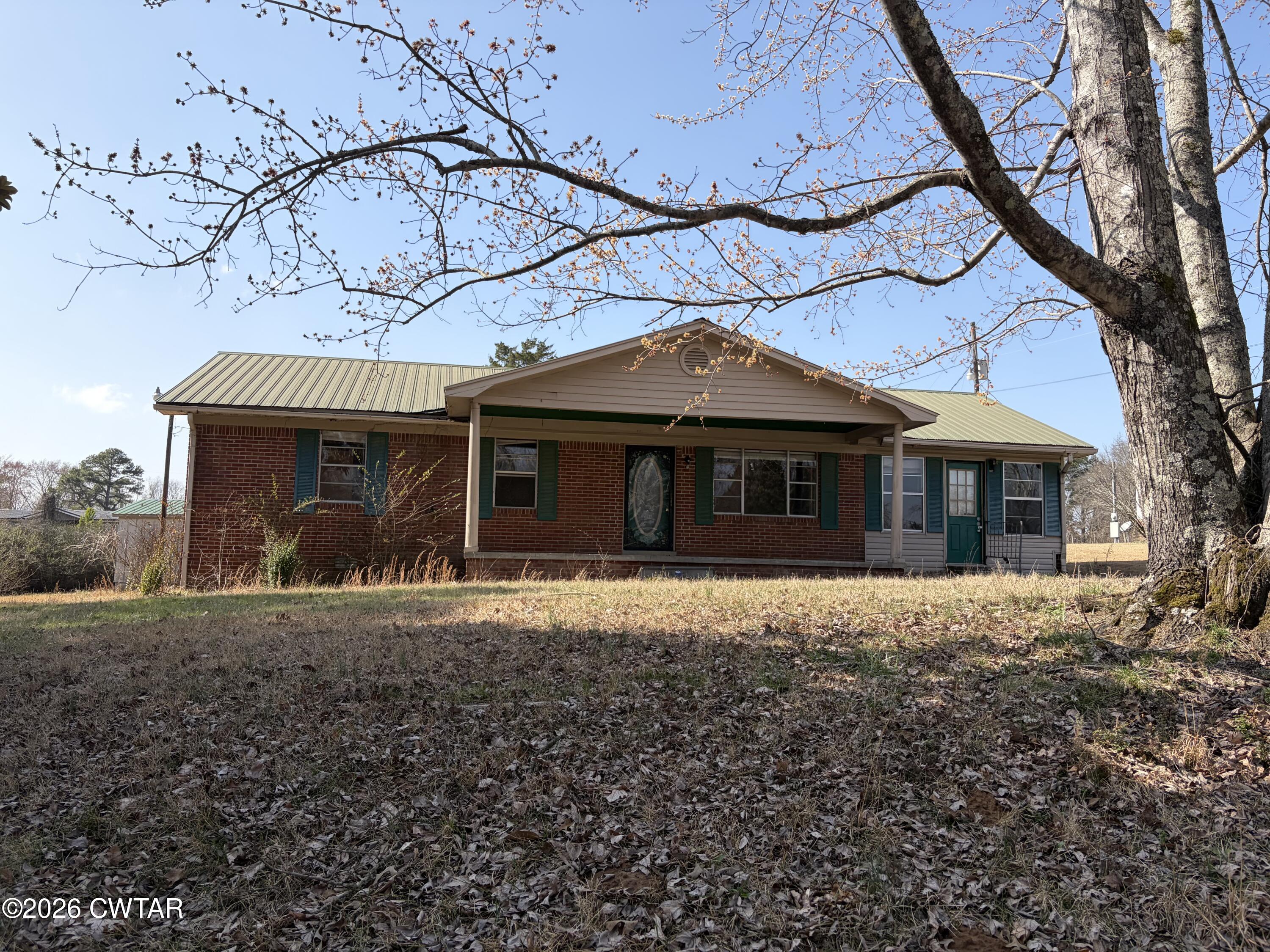13835 Old Jackson Road Whiteville, TN 38075 - Photo 1 of 27 a front view of a house with a garden