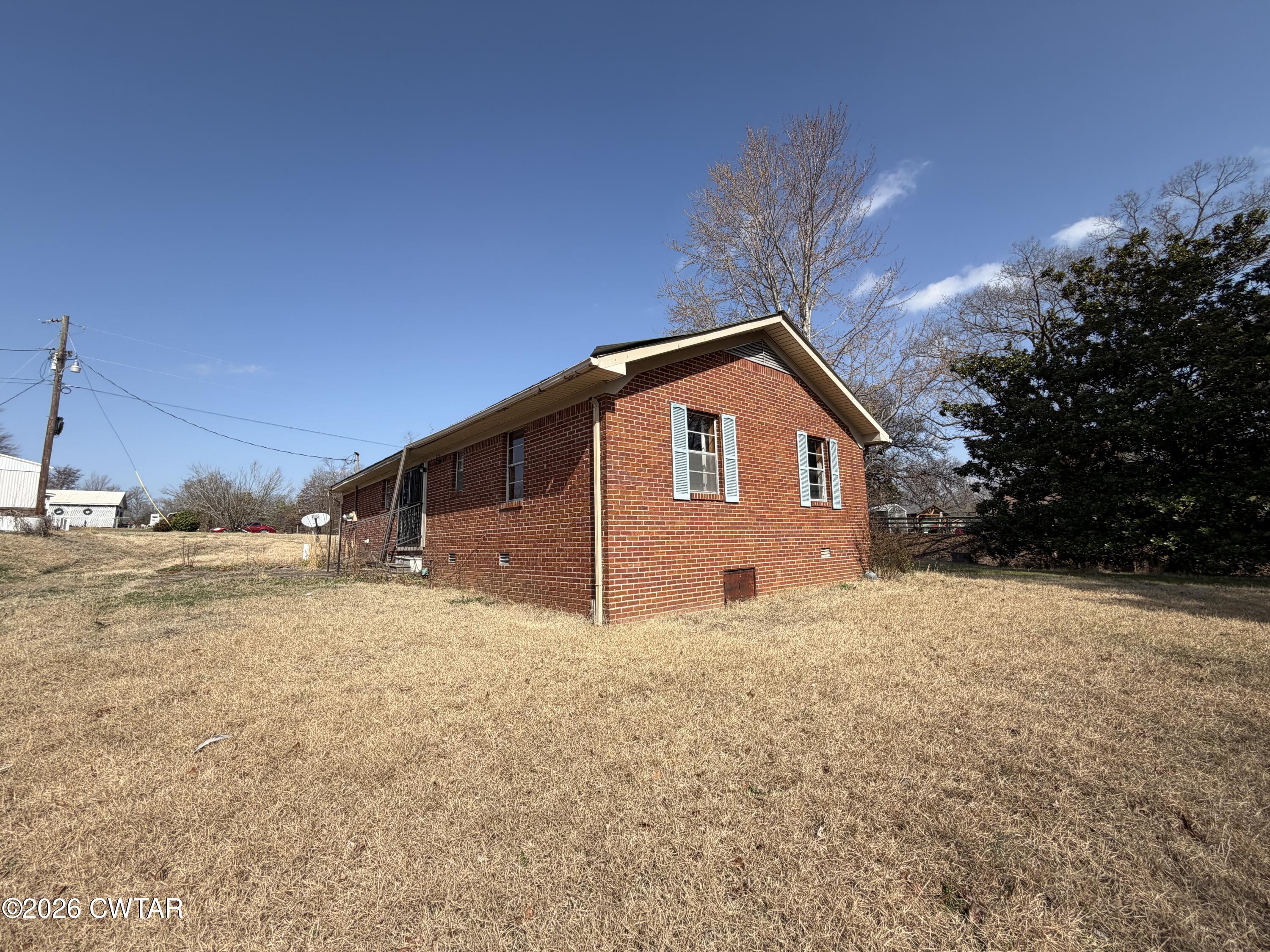 13835 Old Jackson Road Whiteville, TN 38075 - Photo 2 of 27 a view of a house with a yard