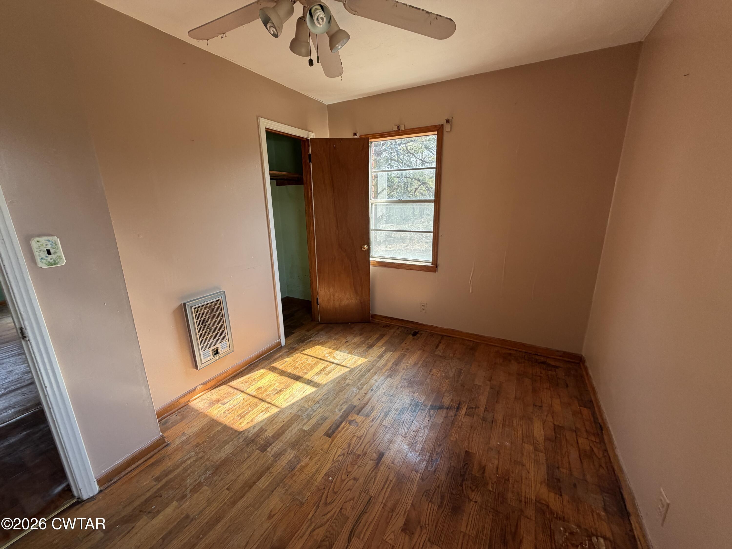 13835 Old Jackson Road Whiteville, TN 38075 - Photo 23 of 27 wooden floor in an empty room with a window
