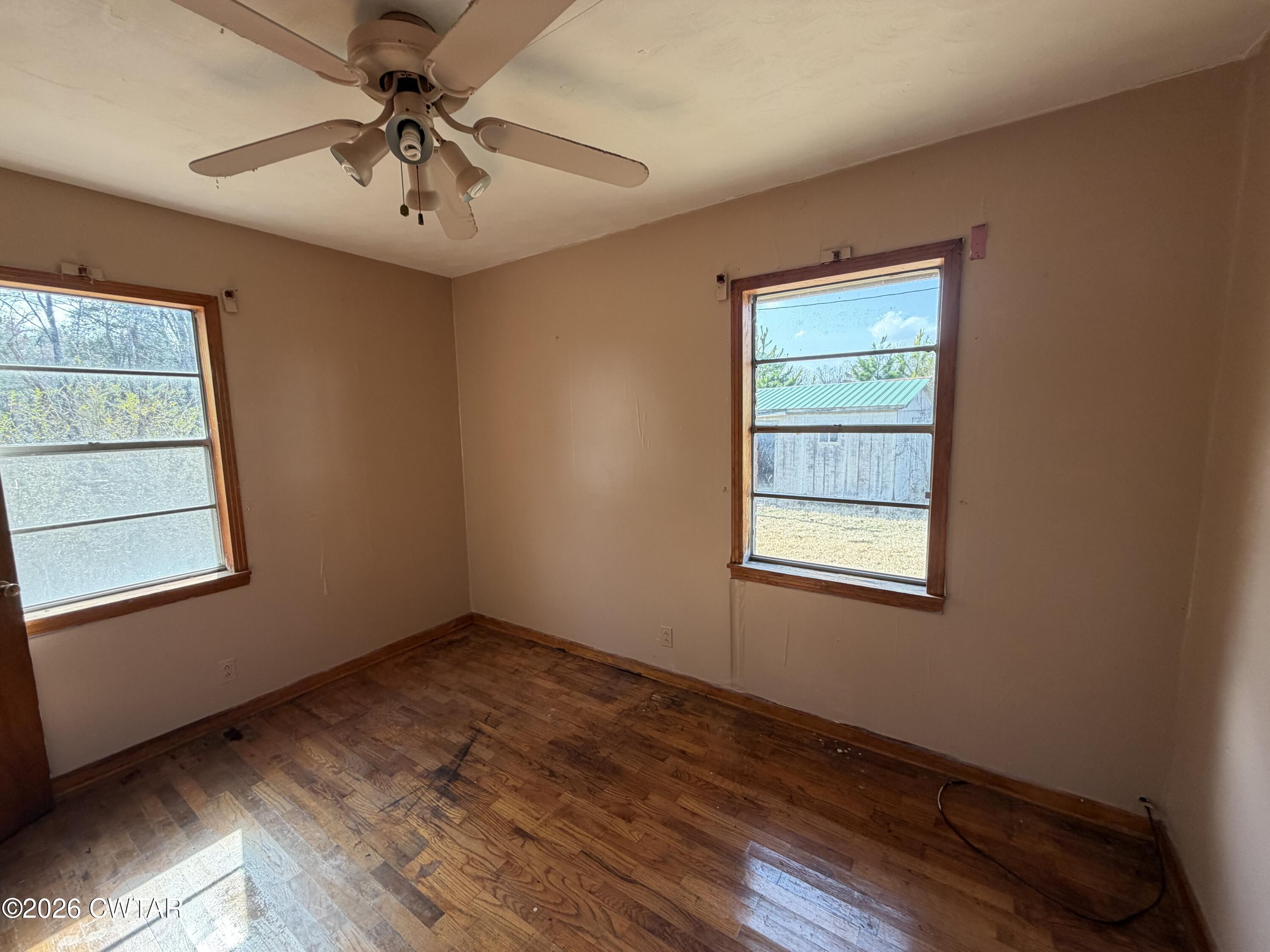 13835 Old Jackson Road Whiteville, TN 38075 - Photo 24 of 27 a view of an empty room with a window and wooden floor