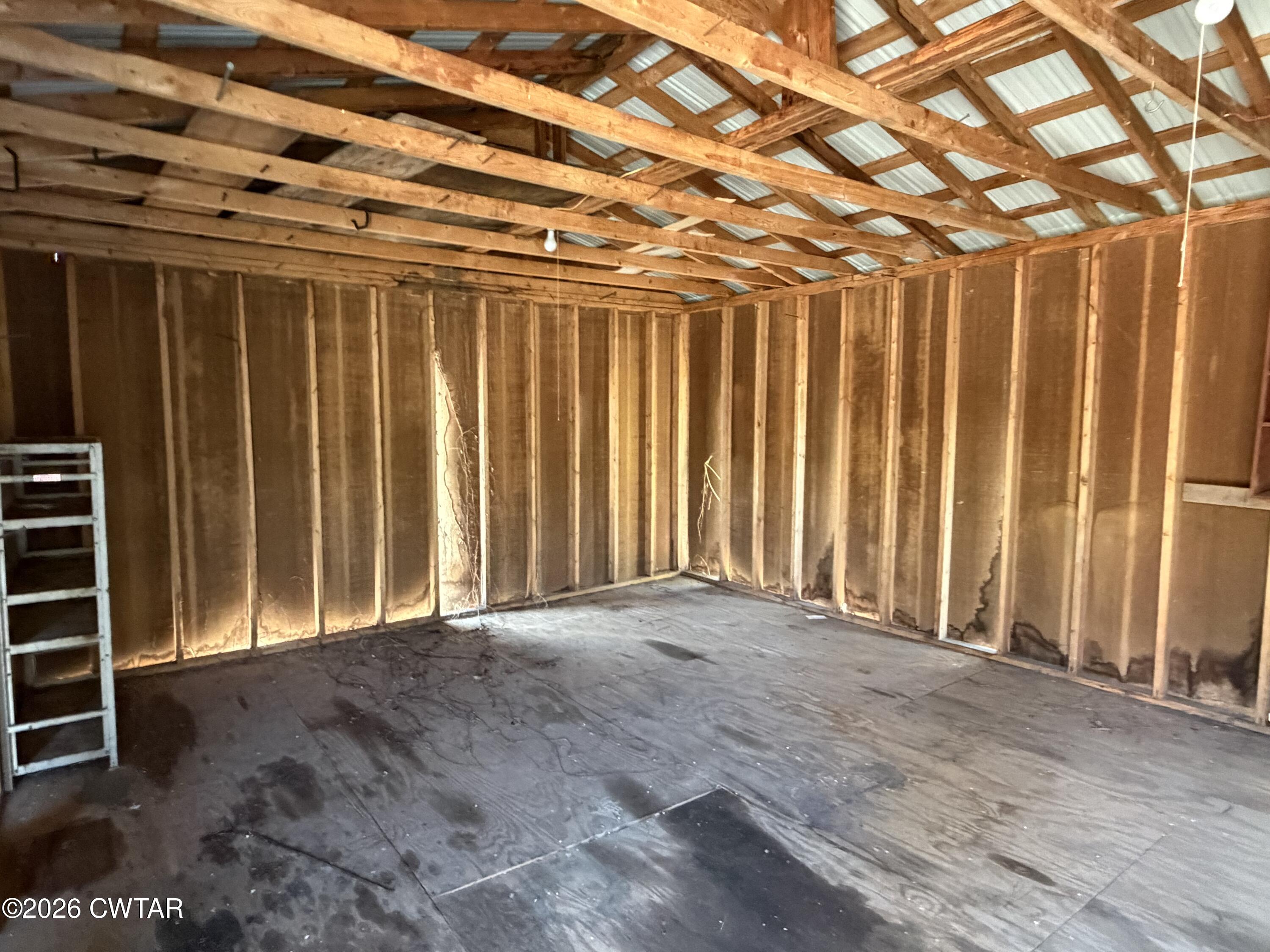 13835 Old Jackson Road Whiteville, TN 38075 - Photo 9 of 27 a view of an empty room with wooden walls