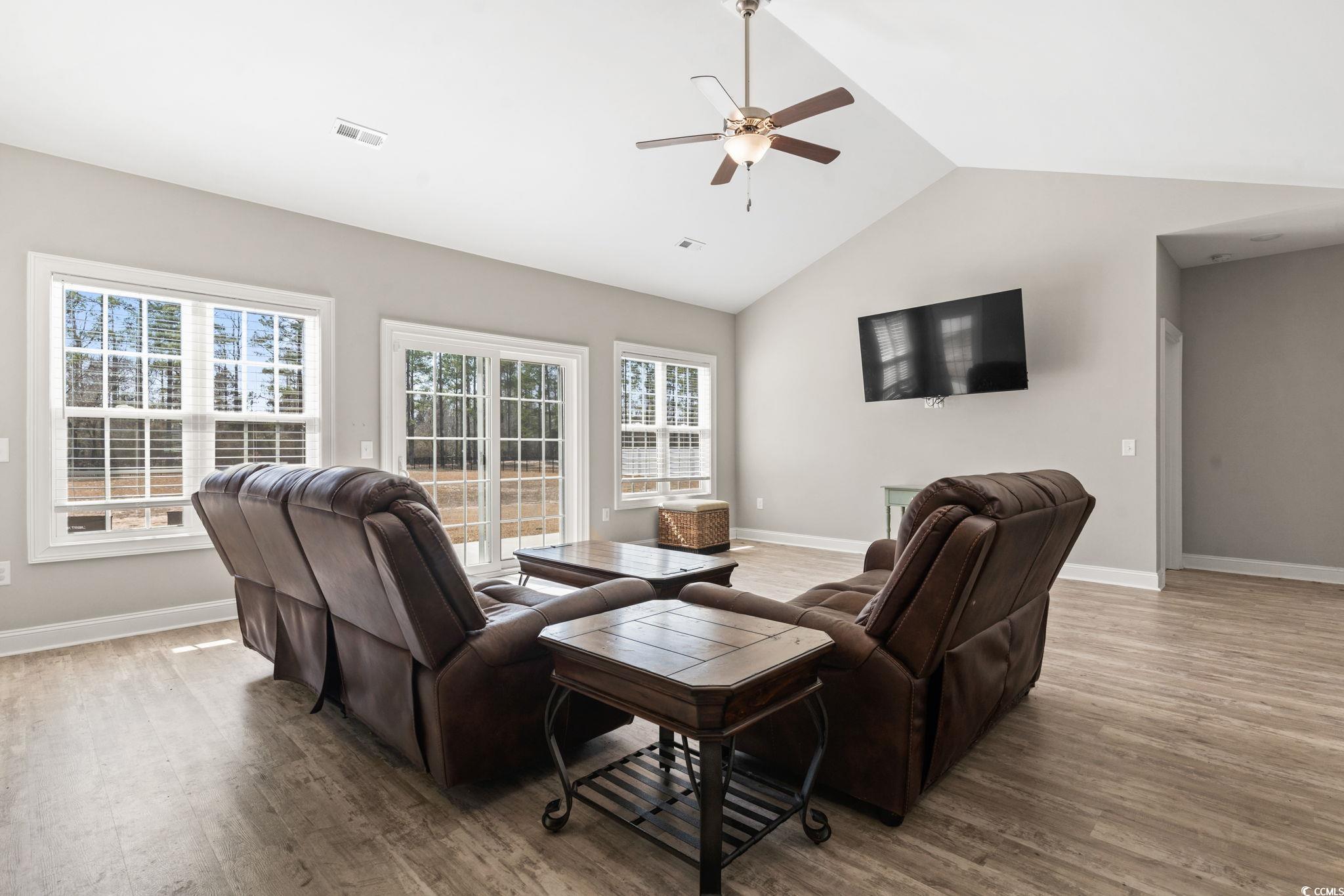 10015 West Highway 19 Loris, SC 29569 - Photo 15 of 40 Living area with vaulted ceiling, wood finished fl