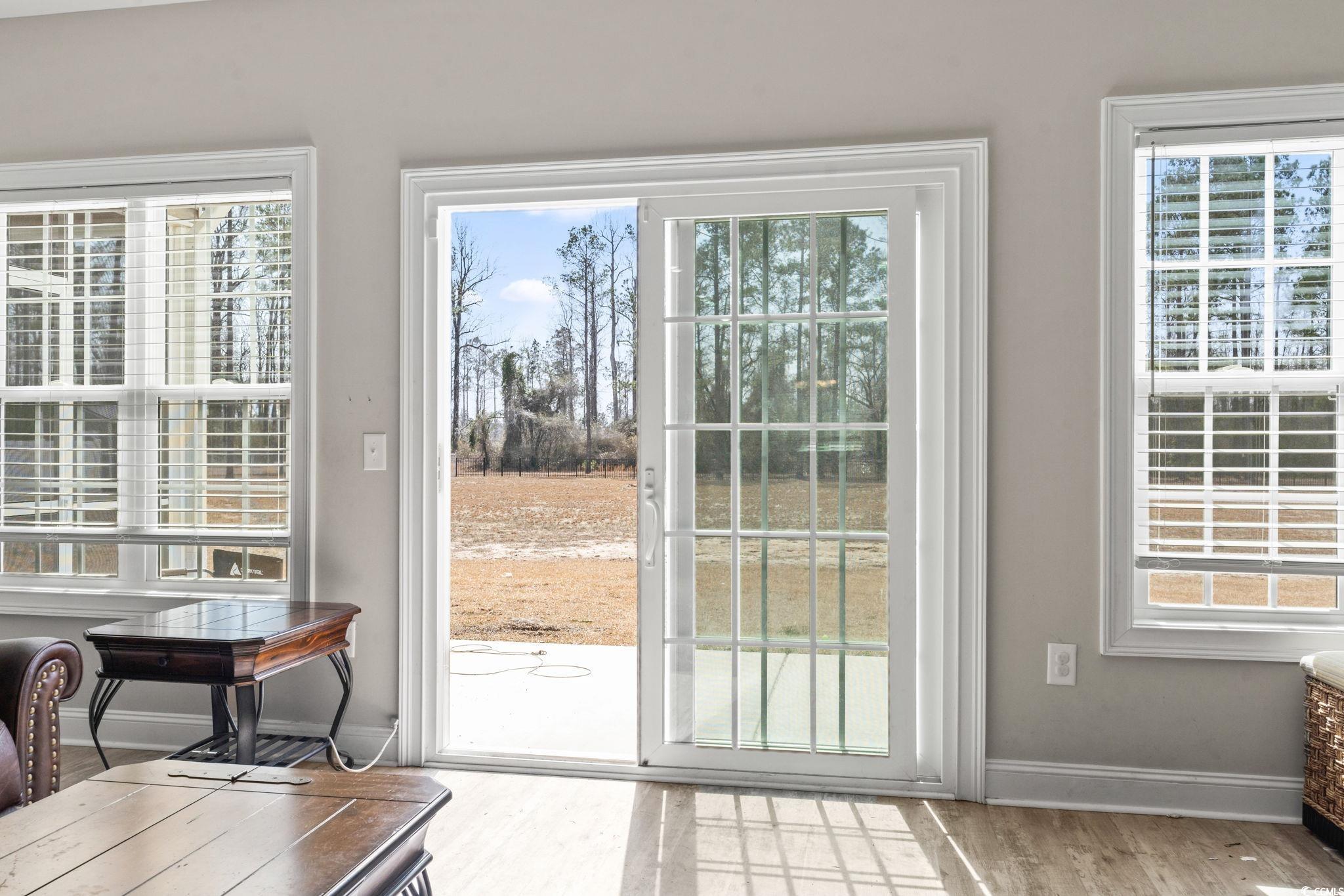 10015 West Highway 19 Loris, SC 29569 - Photo 17 of 40 Doorway with baseboards and wood finished floors