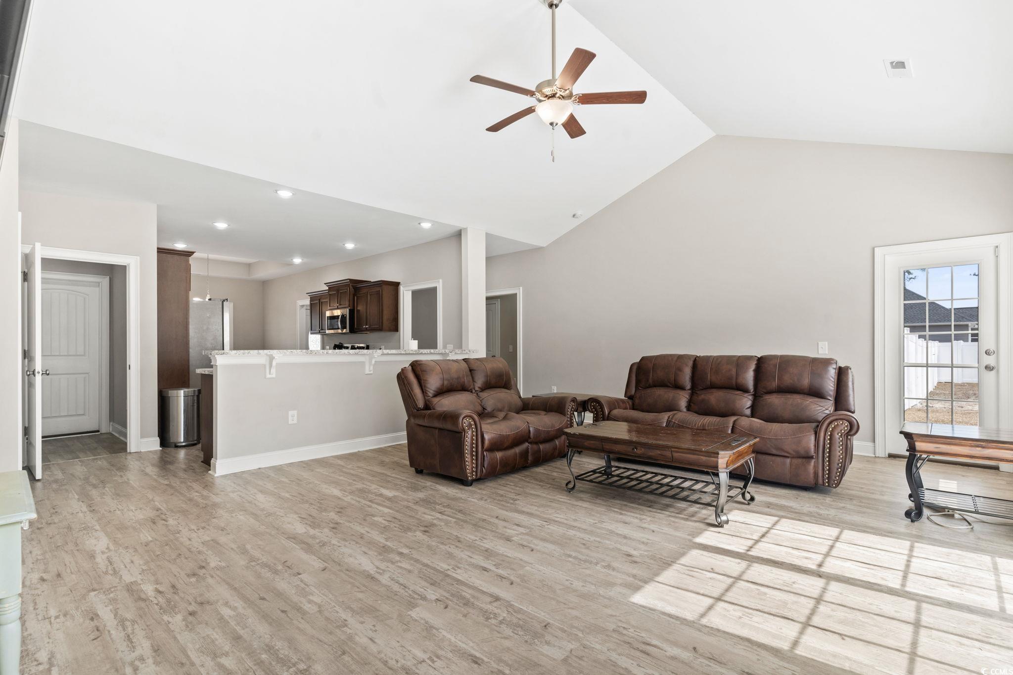 10015 West Highway 19 Loris, SC 29569 - Photo 18 of 40 Living area with ceiling fan, high vaulted ceiling