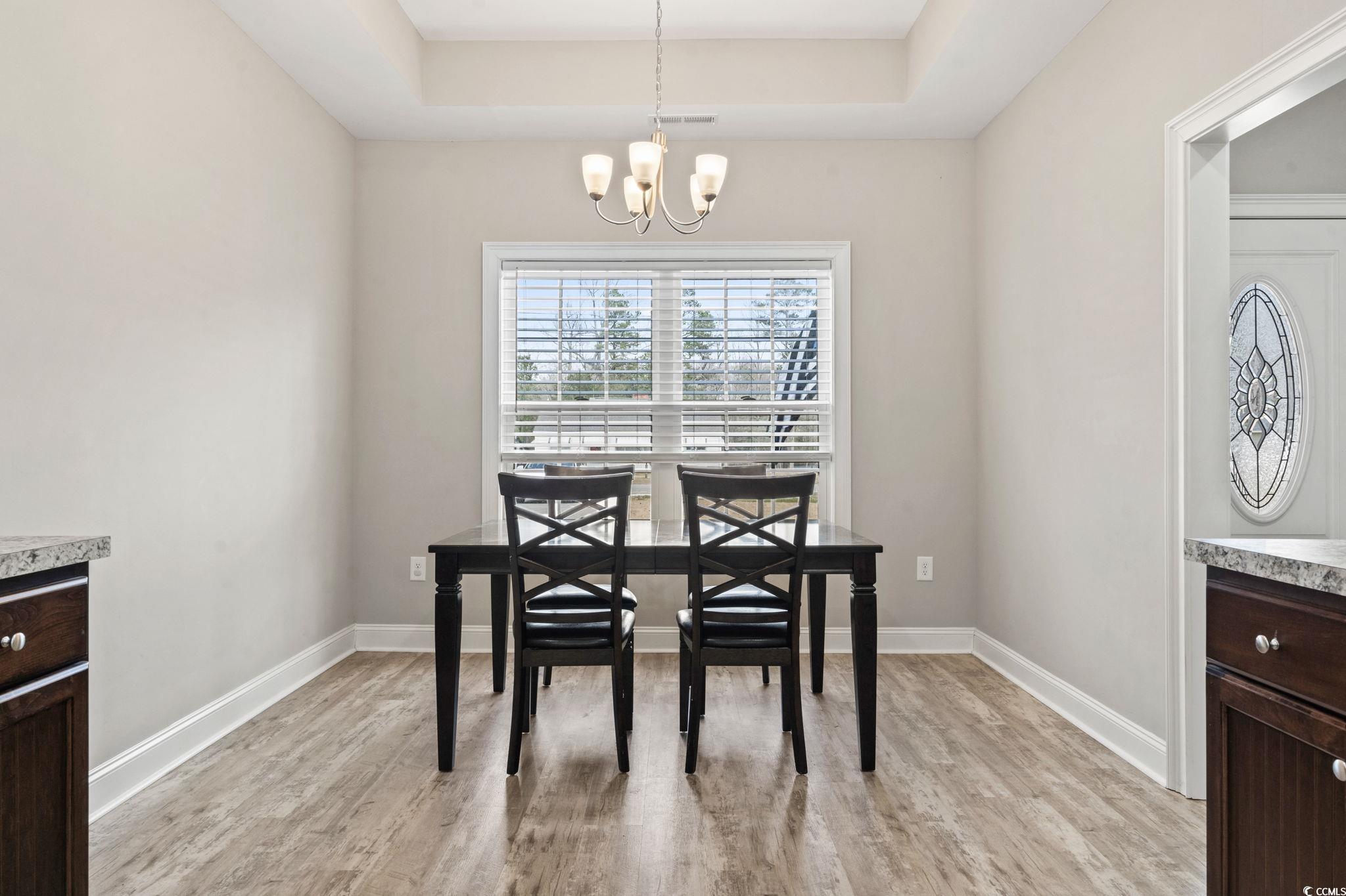 10015 West Highway 19 Loris, SC 29569 - Photo 26 of 40 Dining area with a chandelier, light wood-type flo