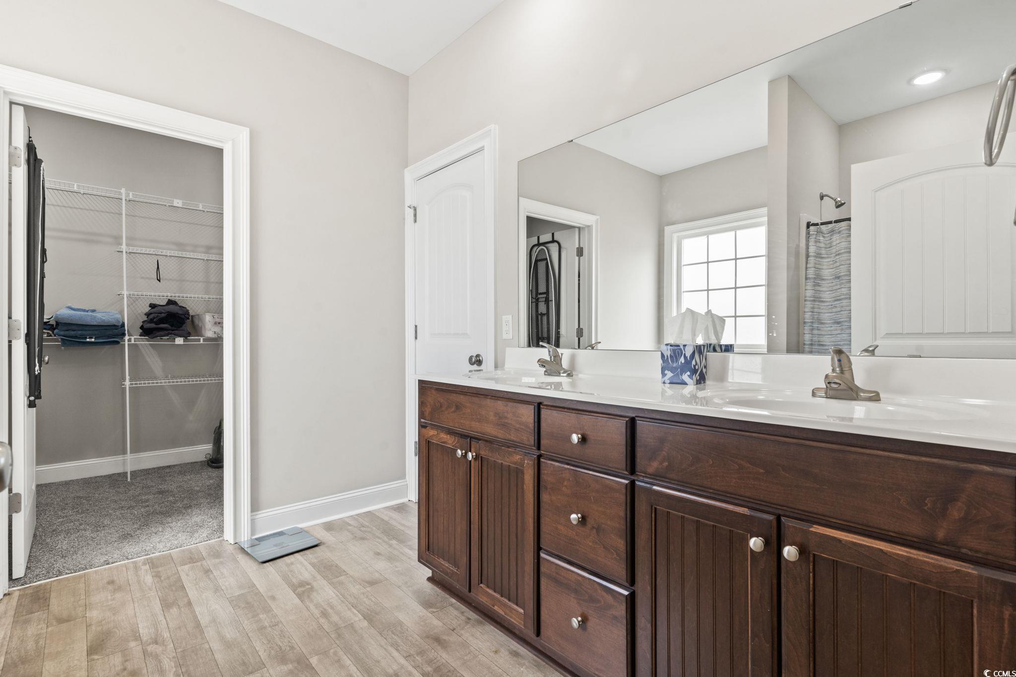 10015 West Highway 19 Loris, SC 29569 - Photo 5 of 40 Bathroom with double vanity, baseboards, a walk in
