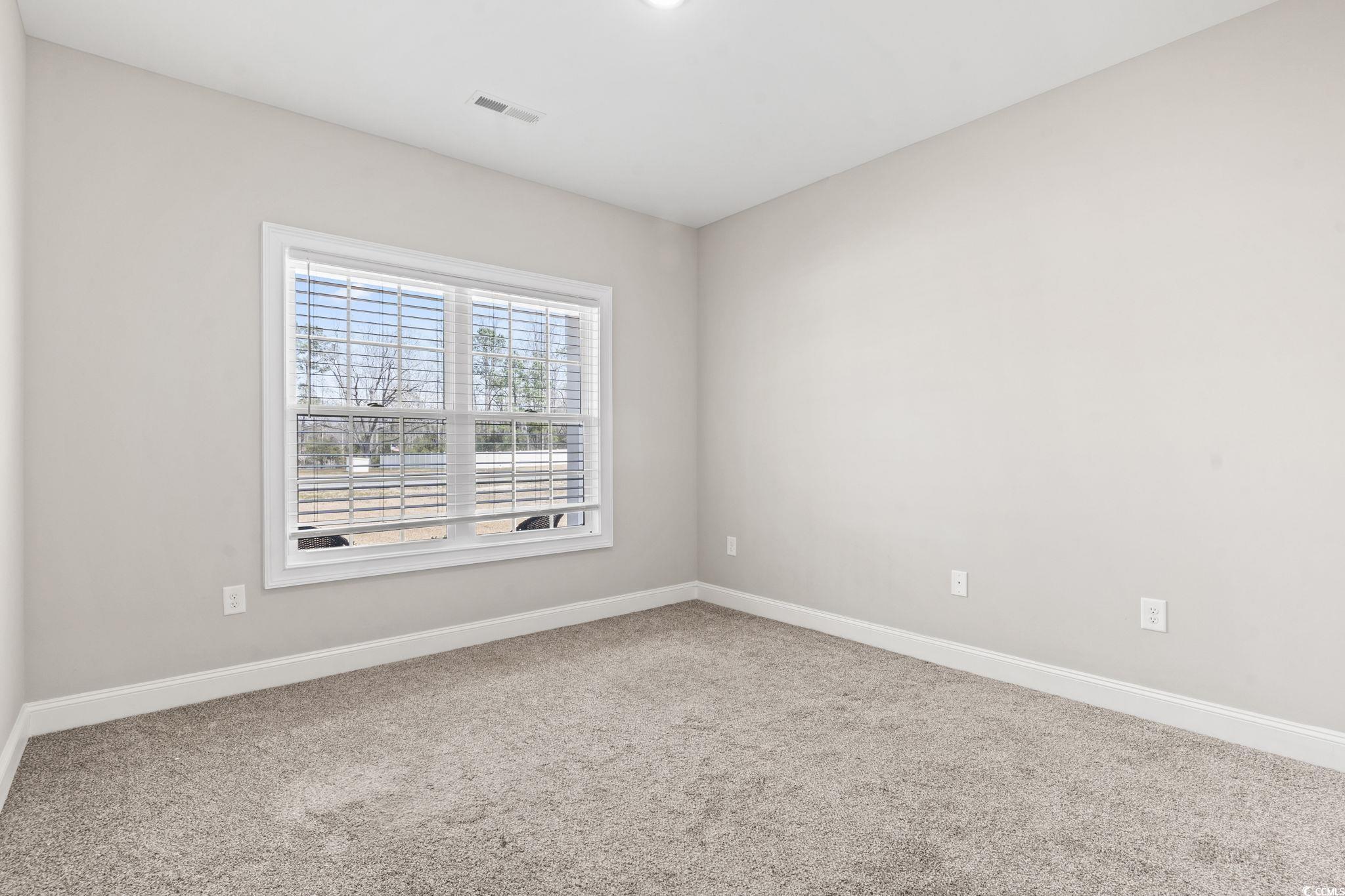 10015 West Highway 19 Loris, SC 29569 - Photo 9 of 40 Spare room with carpet floors, visible vents, and