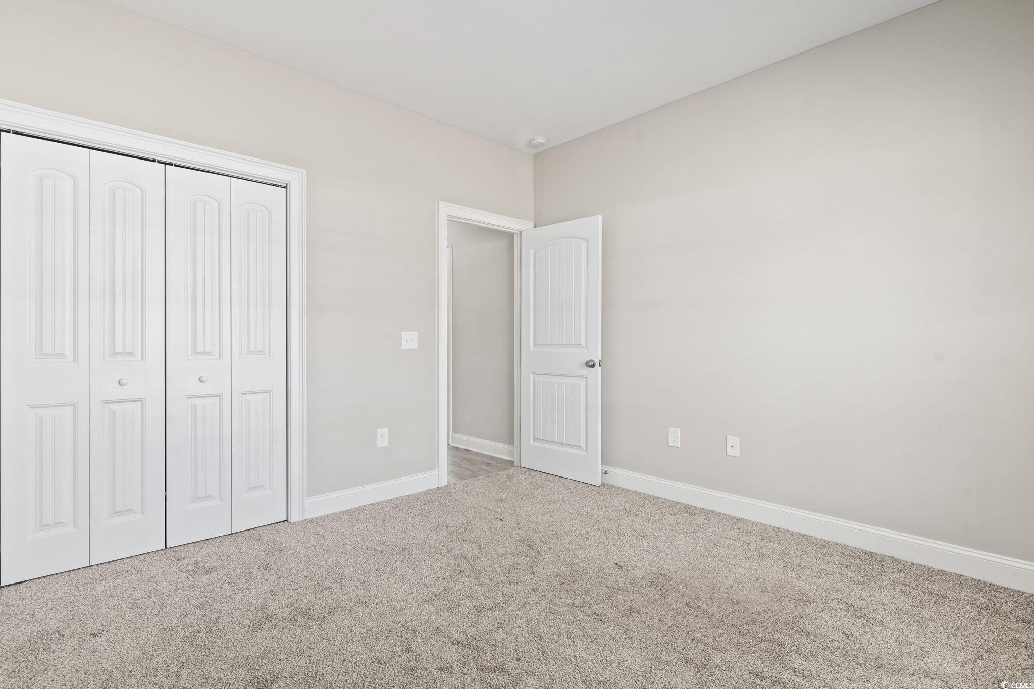 10015 West Highway 19 Loris, SC 29569 - Photo 10 of 40 Unfurnished bedroom featuring carpet, a closet, an