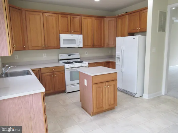 a kitchen with a sink and a stove top oven