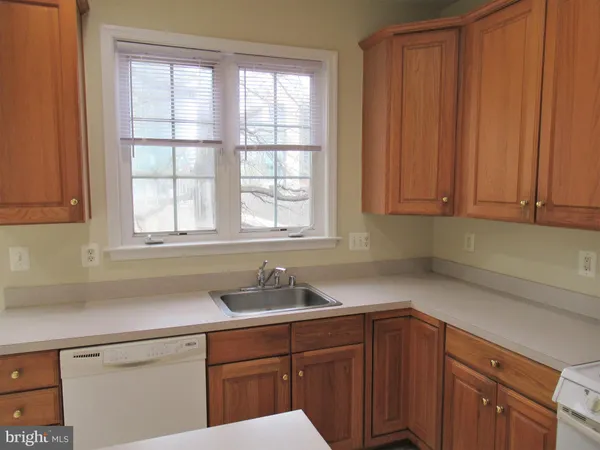 a kitchen with a stove top oven and cabinets
