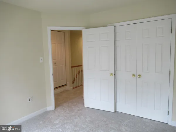 a bathroom with a granite countertop toilet a sink and a mirror
