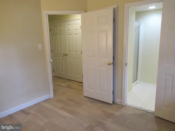 a white toilet sitting next to a white cabinet