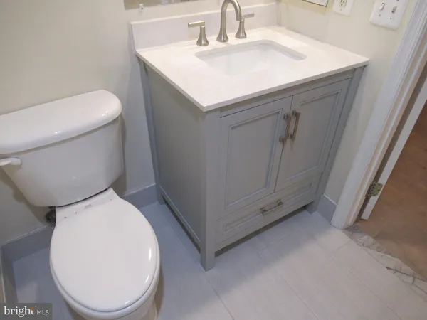 a bathroom with a sink a toilet and mirror
