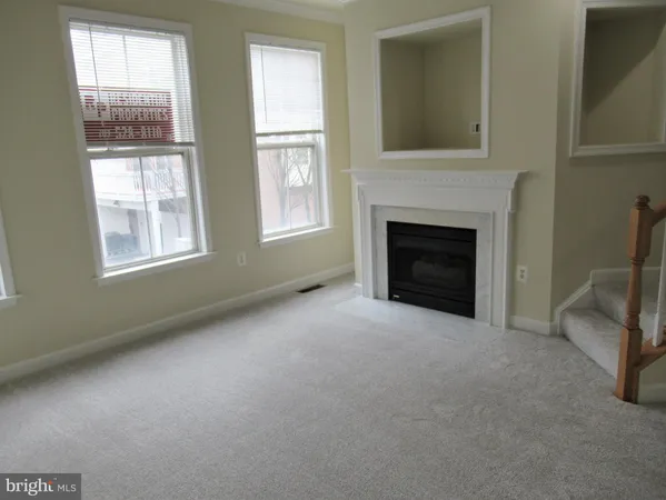 a view of a livingroom with furniture and a fireplace