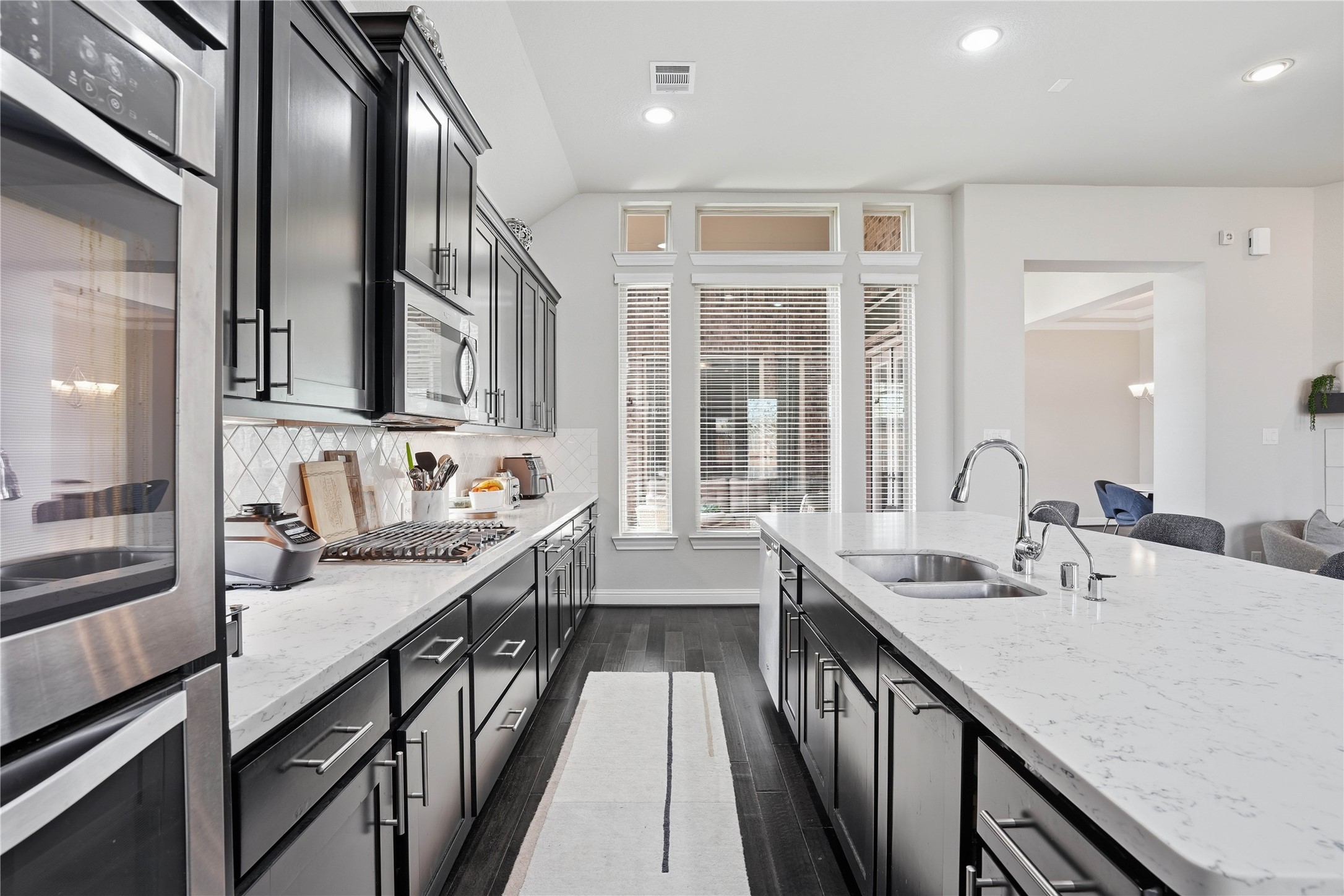 18606 Copano Lane Spring, TX 77379 - Photo 12 of 30 a kitchen with stainless steel appliances granite countertop sink stove and cabinets