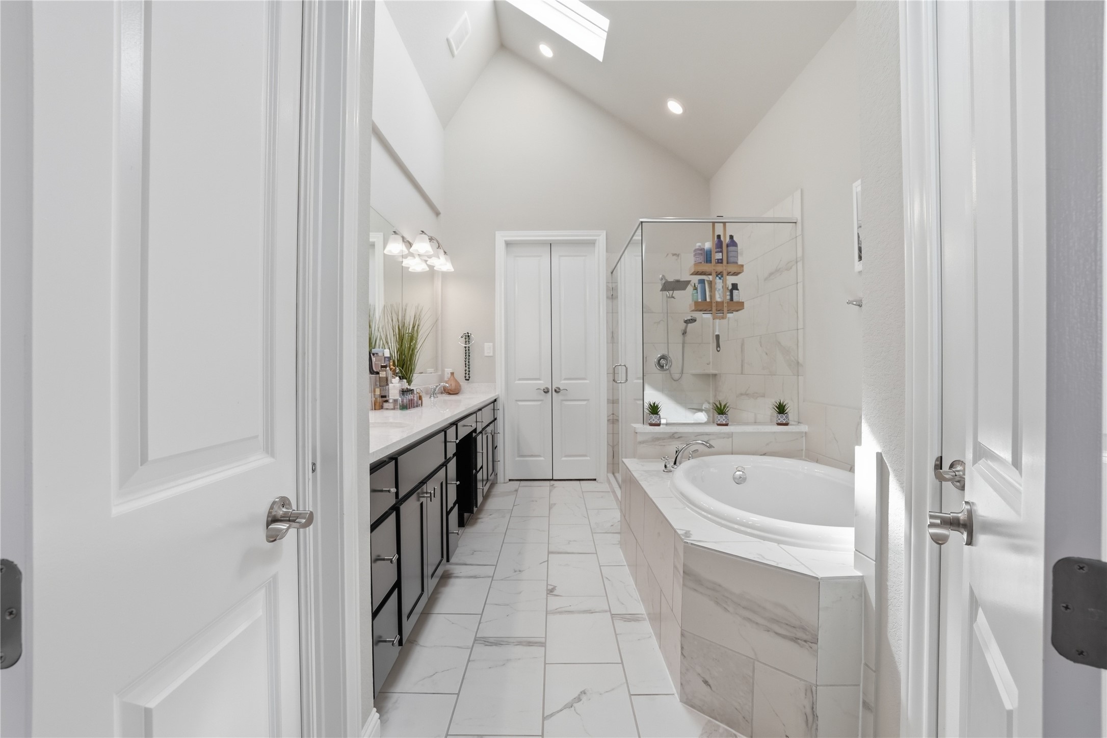 18606 Copano Lane Spring, TX 77379 - Photo 18 of 30 a spacious bathroom with a tub sink and mirror