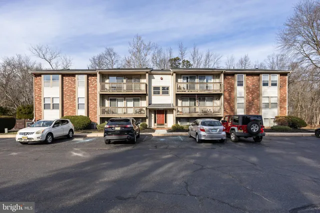 a view of a car is parked in front of a building