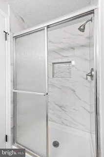 a bathroom with a glass shower door