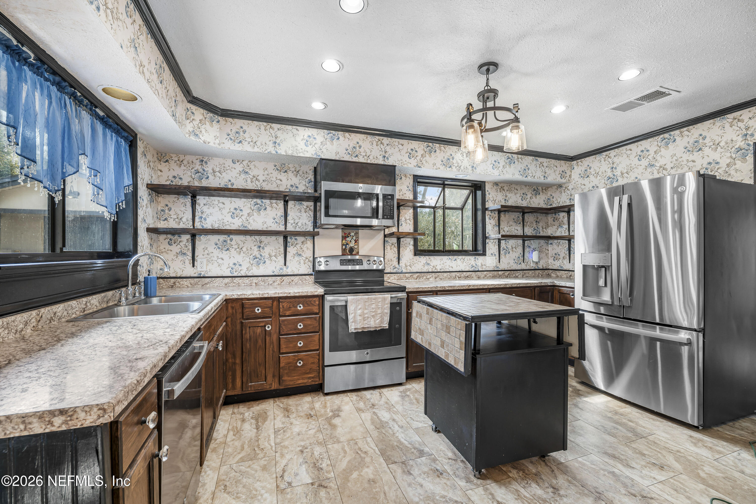 2823 Jewell Road Jacksonville, FL 32216 - Photo 17 of 59 a kitchen with stainless steel appliances granite countertop a stove and a refrigerator