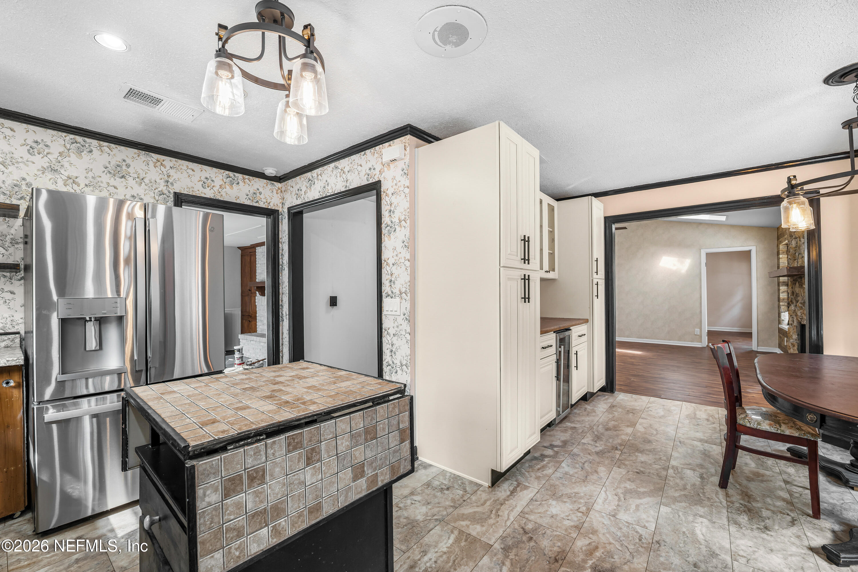 2823 Jewell Road Jacksonville, FL 32216 - Photo 20 of 59 a kitchen with stainless steel appliances granite countertop a stove a refrigerator and a dining table with wooden floor