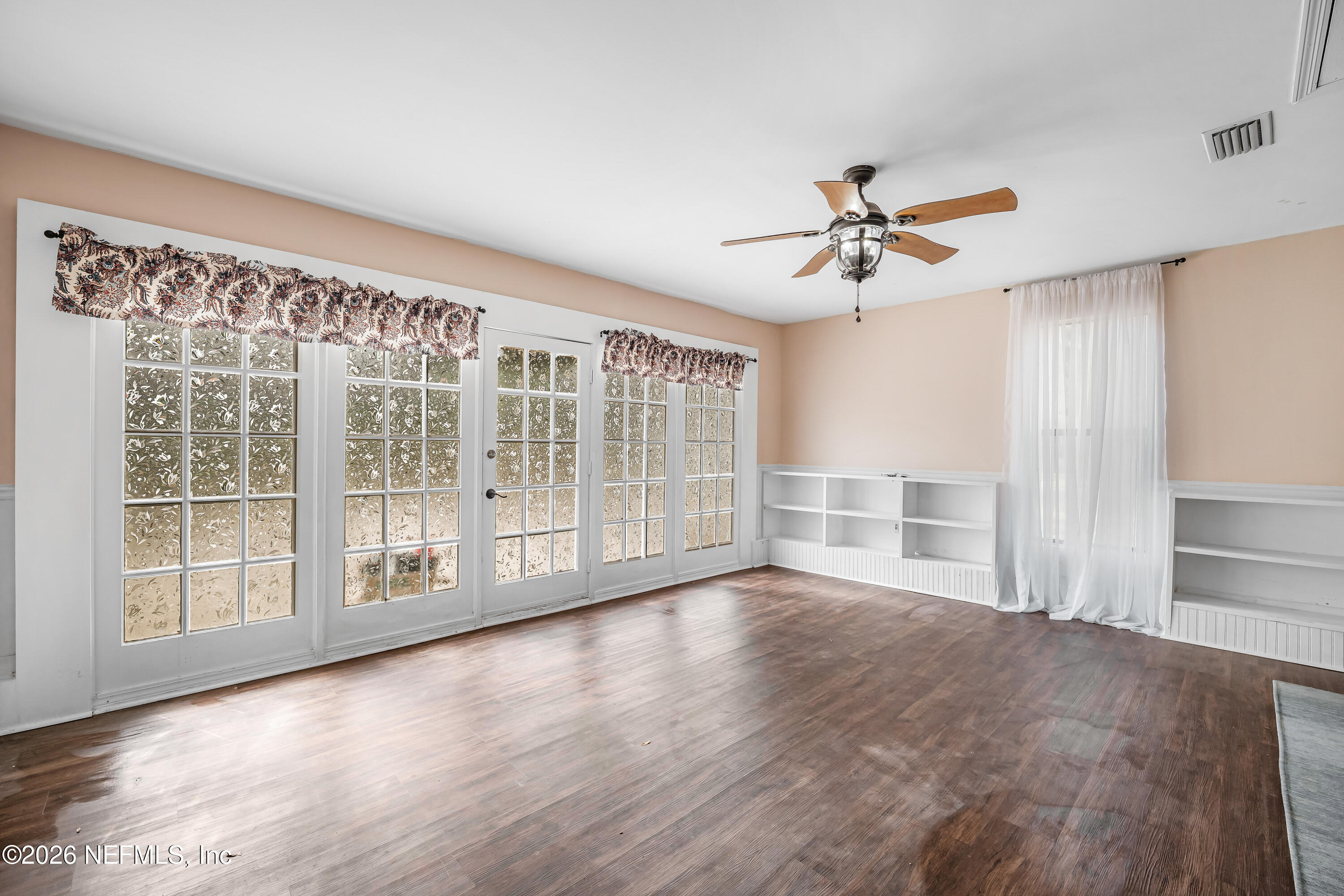 2823 Jewell Road Jacksonville, FL 32216 - Photo 22 of 59 a view of an empty room with a window and wooden floor