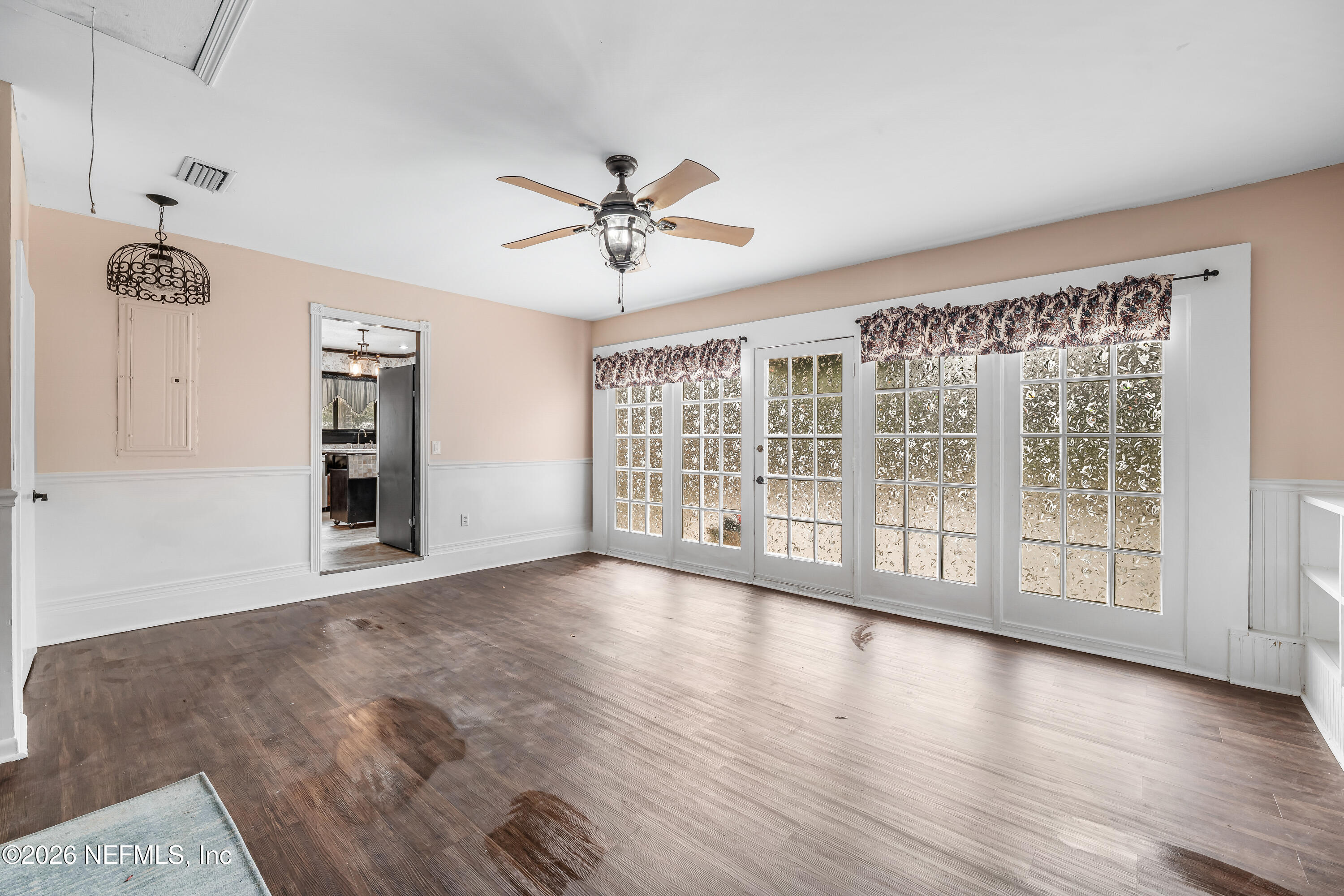 2823 Jewell Road Jacksonville, FL 32216 - Photo 23 of 59 a view of an empty room with a window and wooden floor
