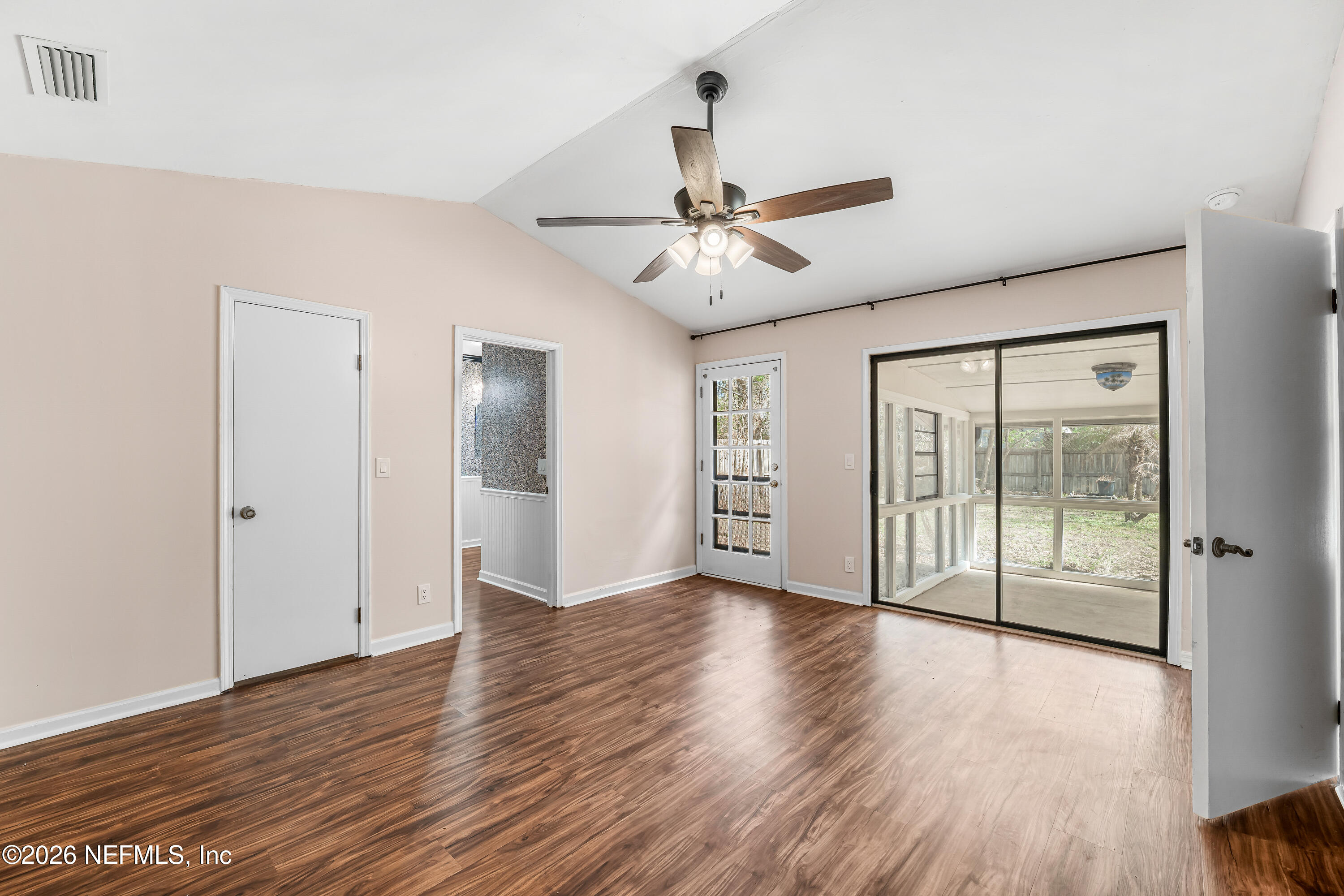 2823 Jewell Road Jacksonville, FL 32216 - Photo 25 of 59 a view of an empty room with wooden floor and a window