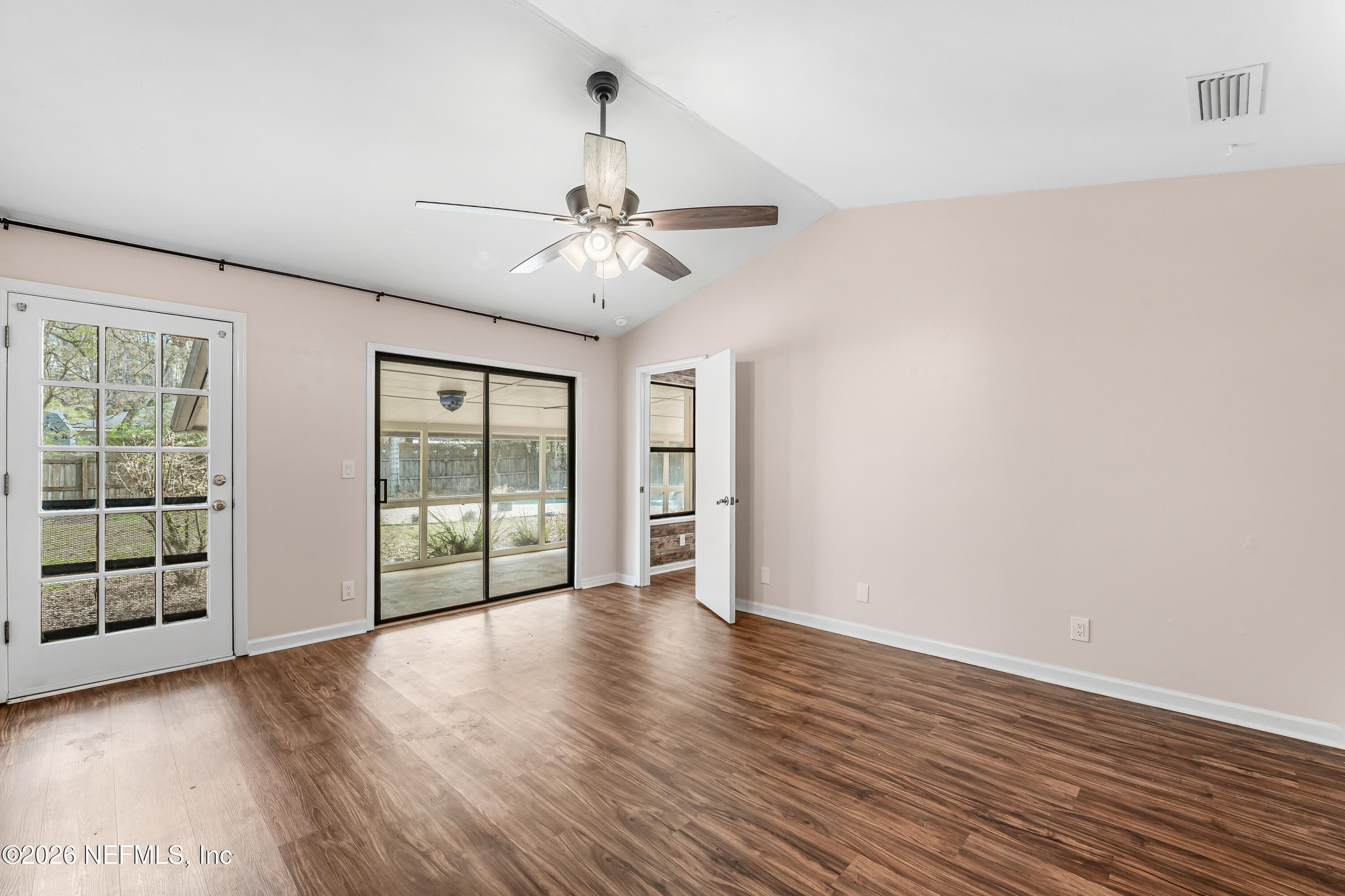 2823 Jewell Road Jacksonville, FL 32216 - Photo 26 of 59 a view of an empty room with a window and wooden floor