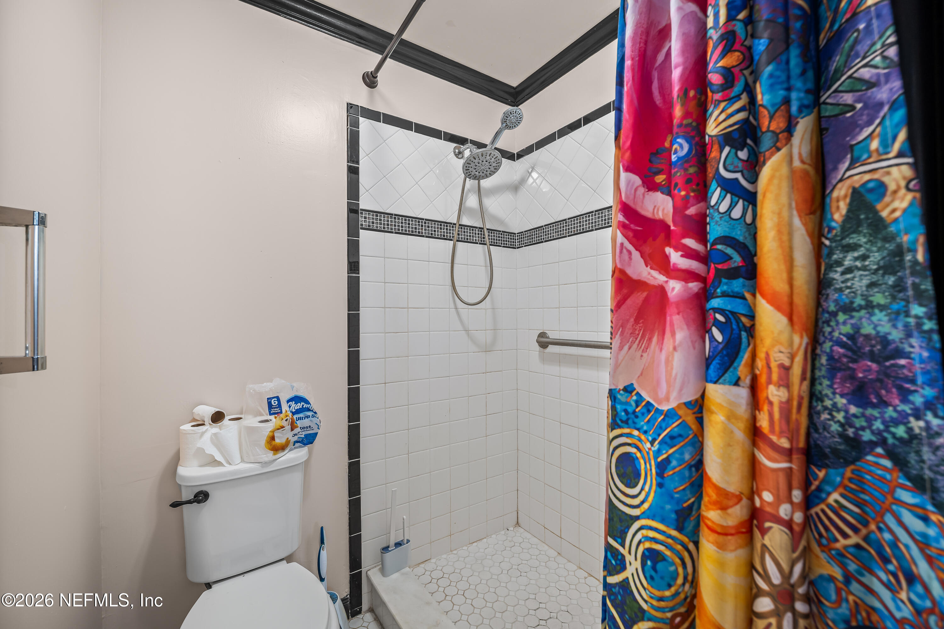 2823 Jewell Road Jacksonville, FL 32216 - Photo 29 of 59 a bathroom with a toilet and shower curtain