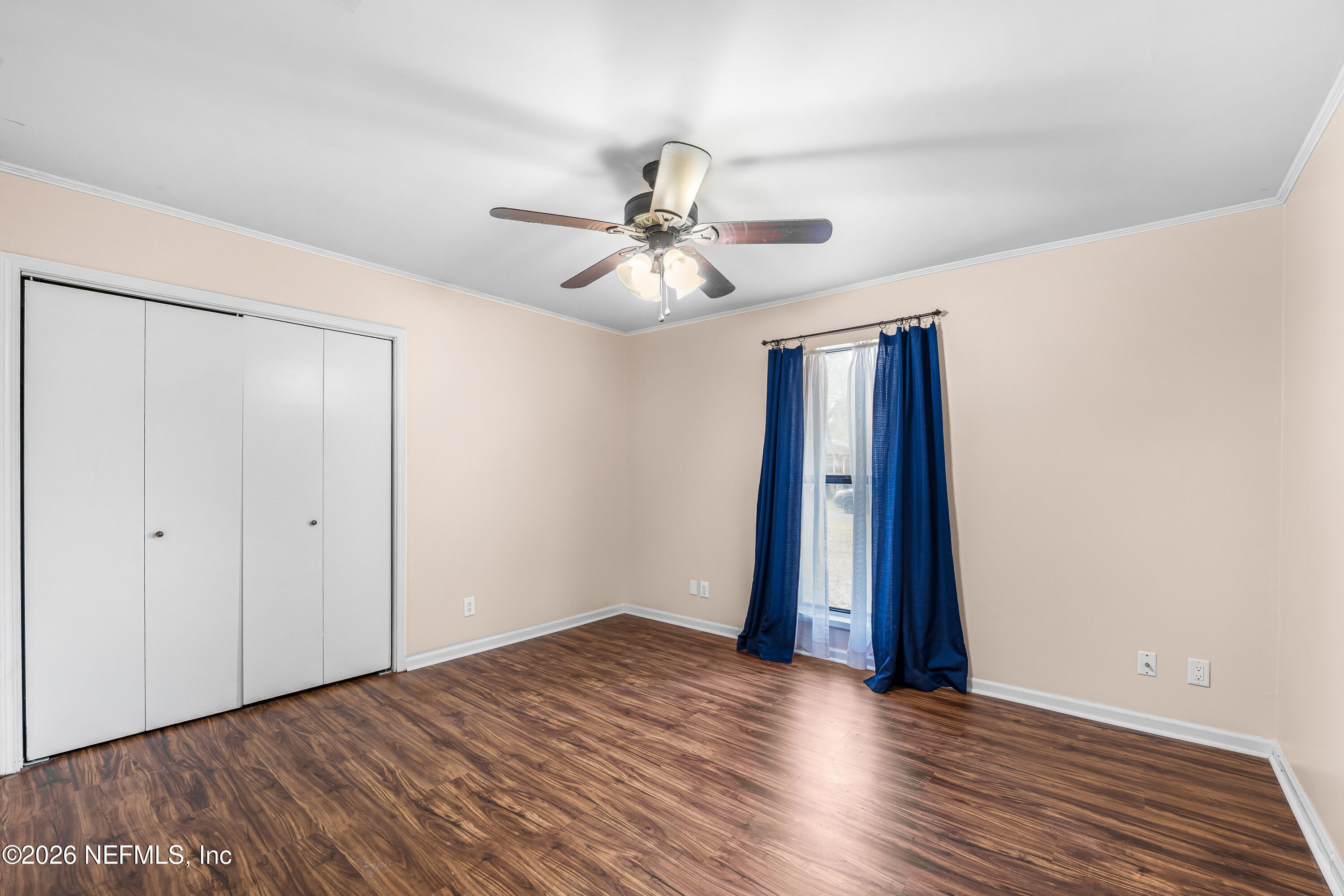 2823 Jewell Road Jacksonville, FL 32216 - Photo 30 of 59 a view of an empty room with window and a ceiling fan