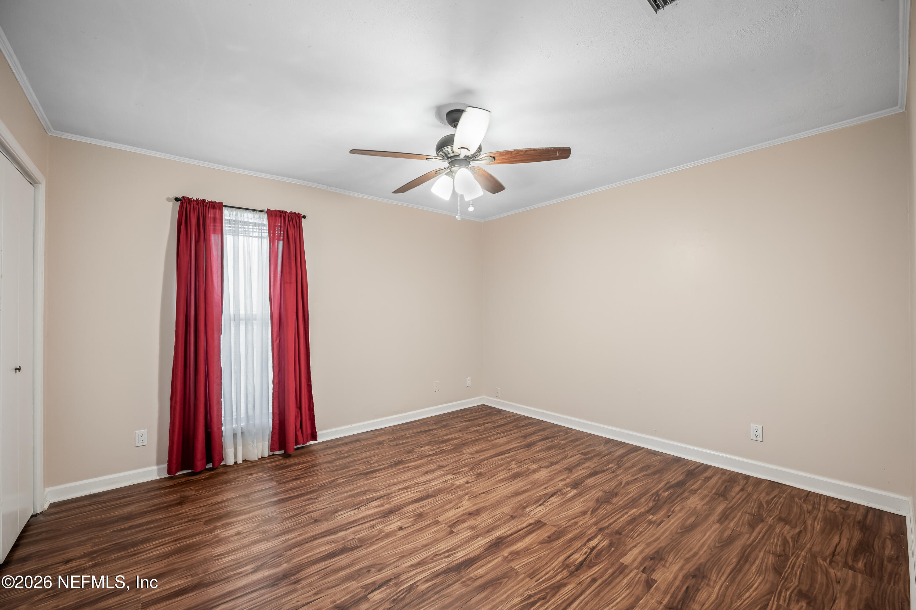 2823 Jewell Road Jacksonville, FL 32216 - Photo 32 of 59 a view of a room with a chandelier fan and wooden floor