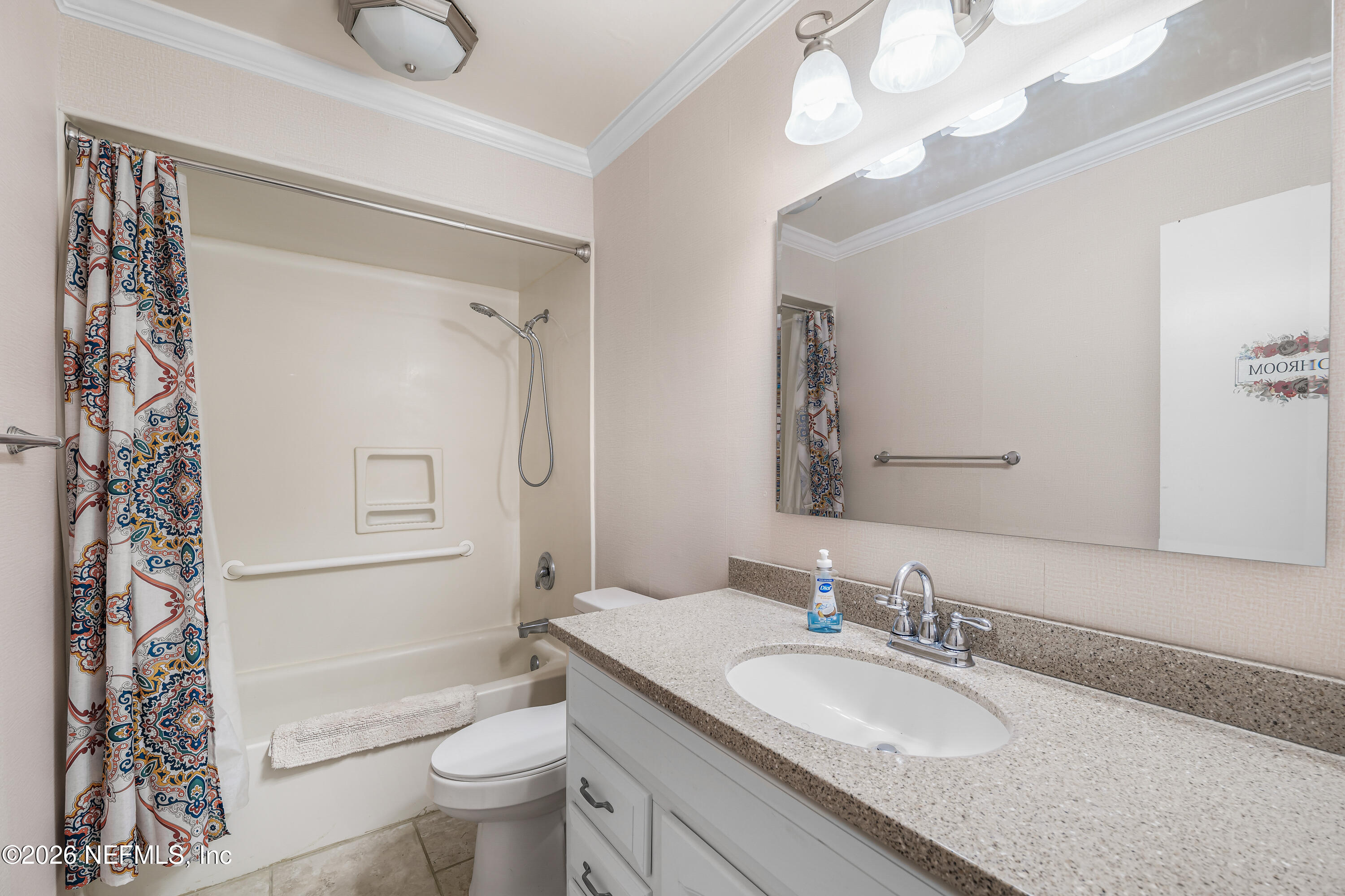 2823 Jewell Road Jacksonville, FL 32216 - Photo 34 of 59 a bathroom with a granite countertop sink a toilet and a mirror