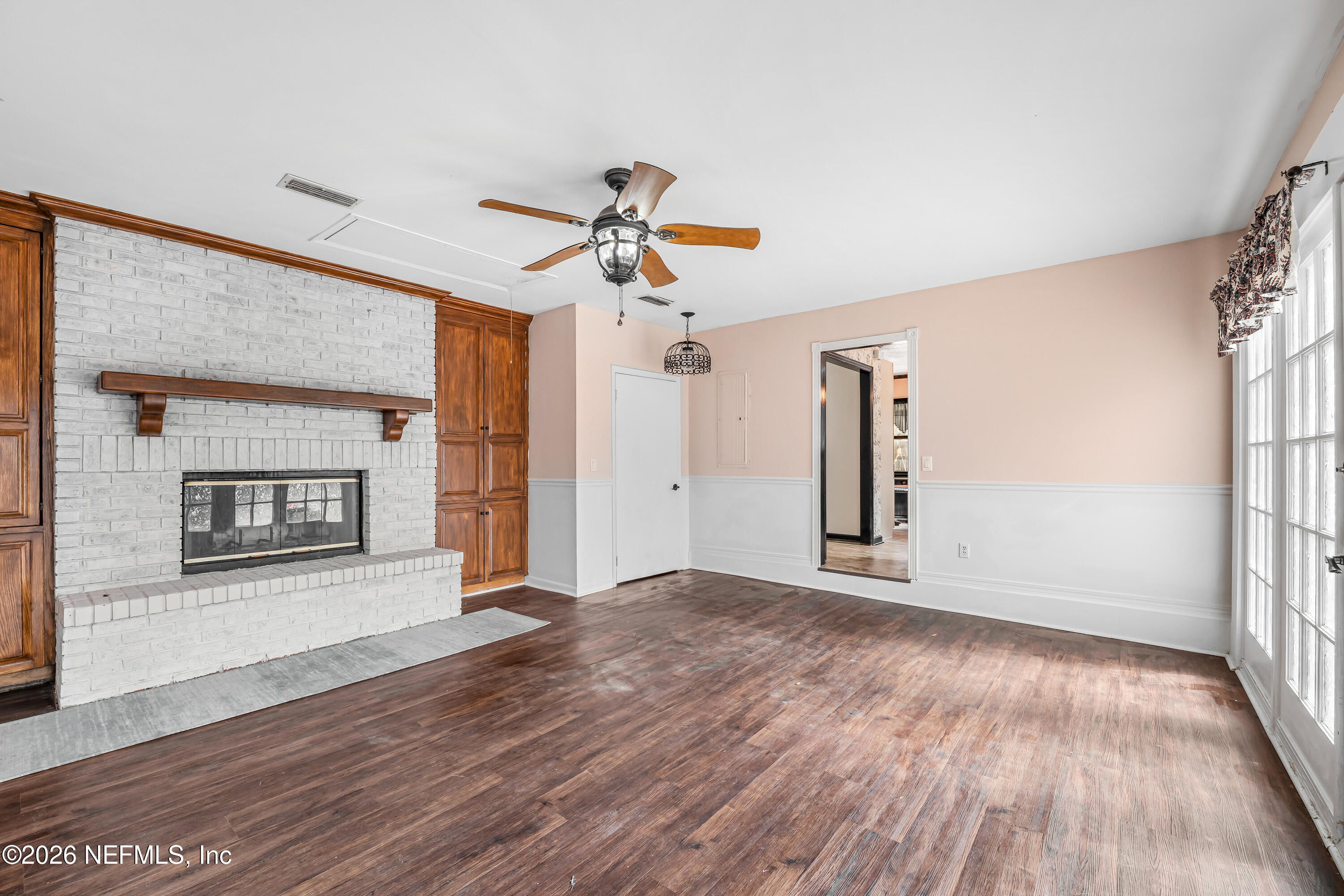2823 Jewell Road Jacksonville, FL 32216 - Photo 7 of 59 a view of empty room with wooden floor and fireplace