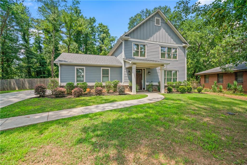 a front view of a house with a yard and porch